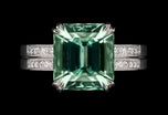A Step-Cut Green Tourmaline single stone ring with Diamond set shoulders