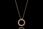 A diamond circlet pendant in yellow gold