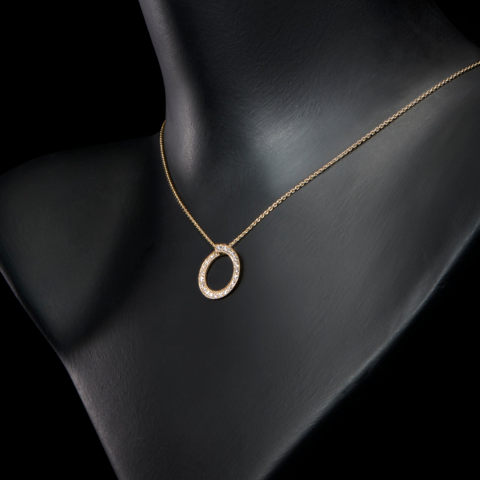 A diamond circlet pendant in yellow gold