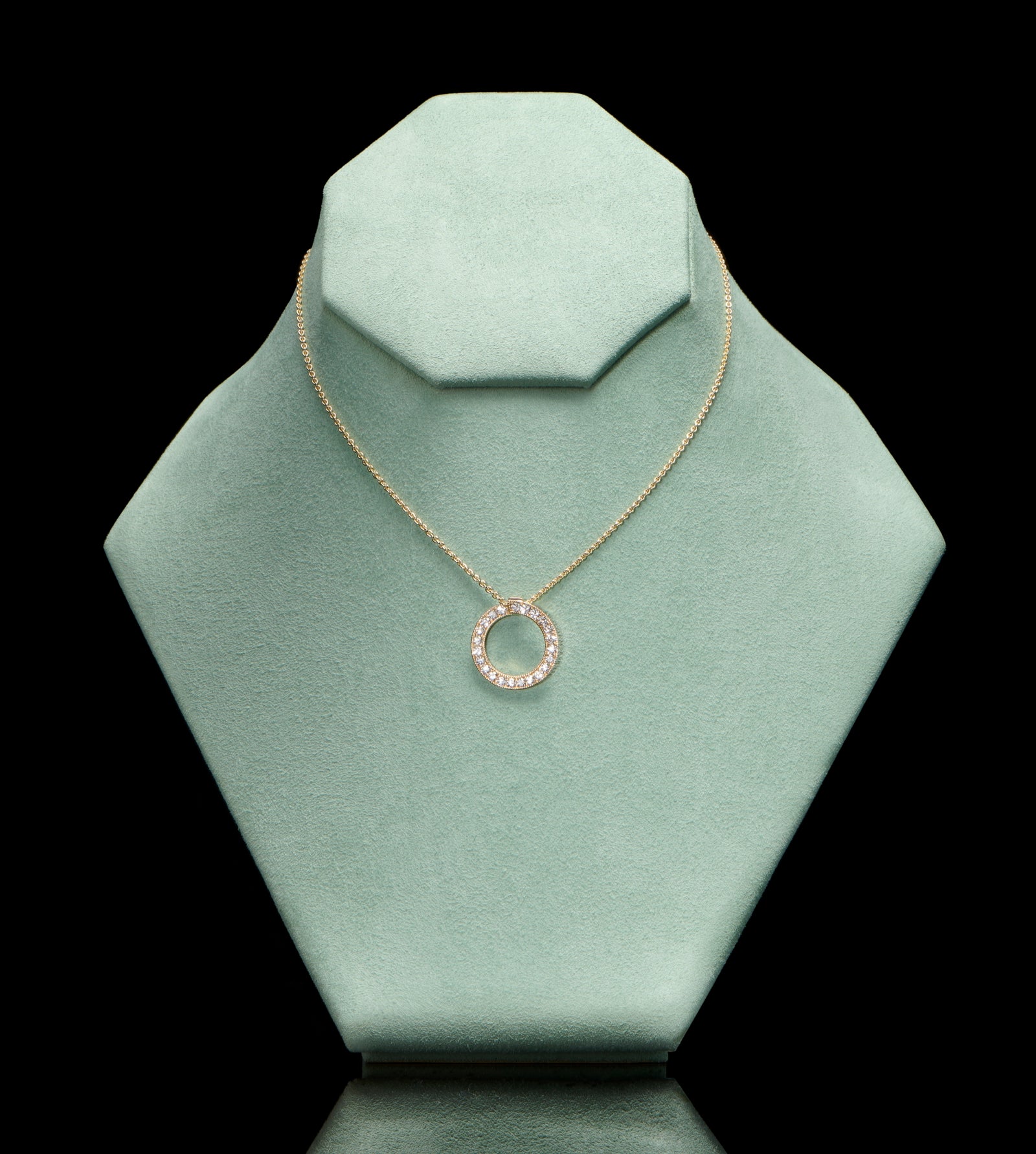 A diamond circlet pendant in yellow gold