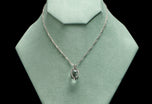 A rock crystal & diamond orb pendant