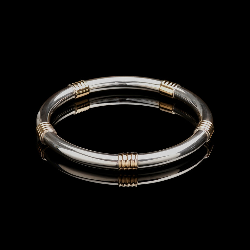 A Cousins ONE IN FIVE. A solid silver & 18 carat yellow gold bangle