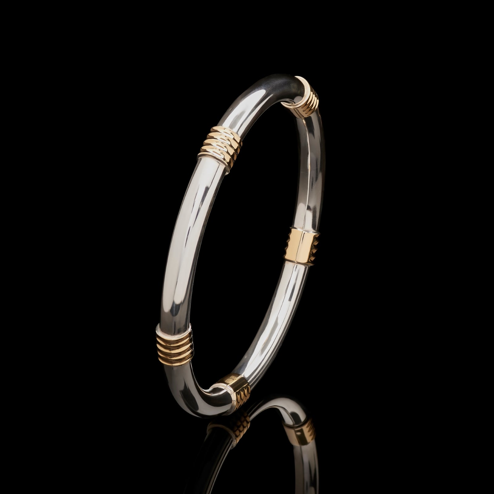 A Cousins ONE IN FIVE. A solid silver & 18 carat yellow gold bangle