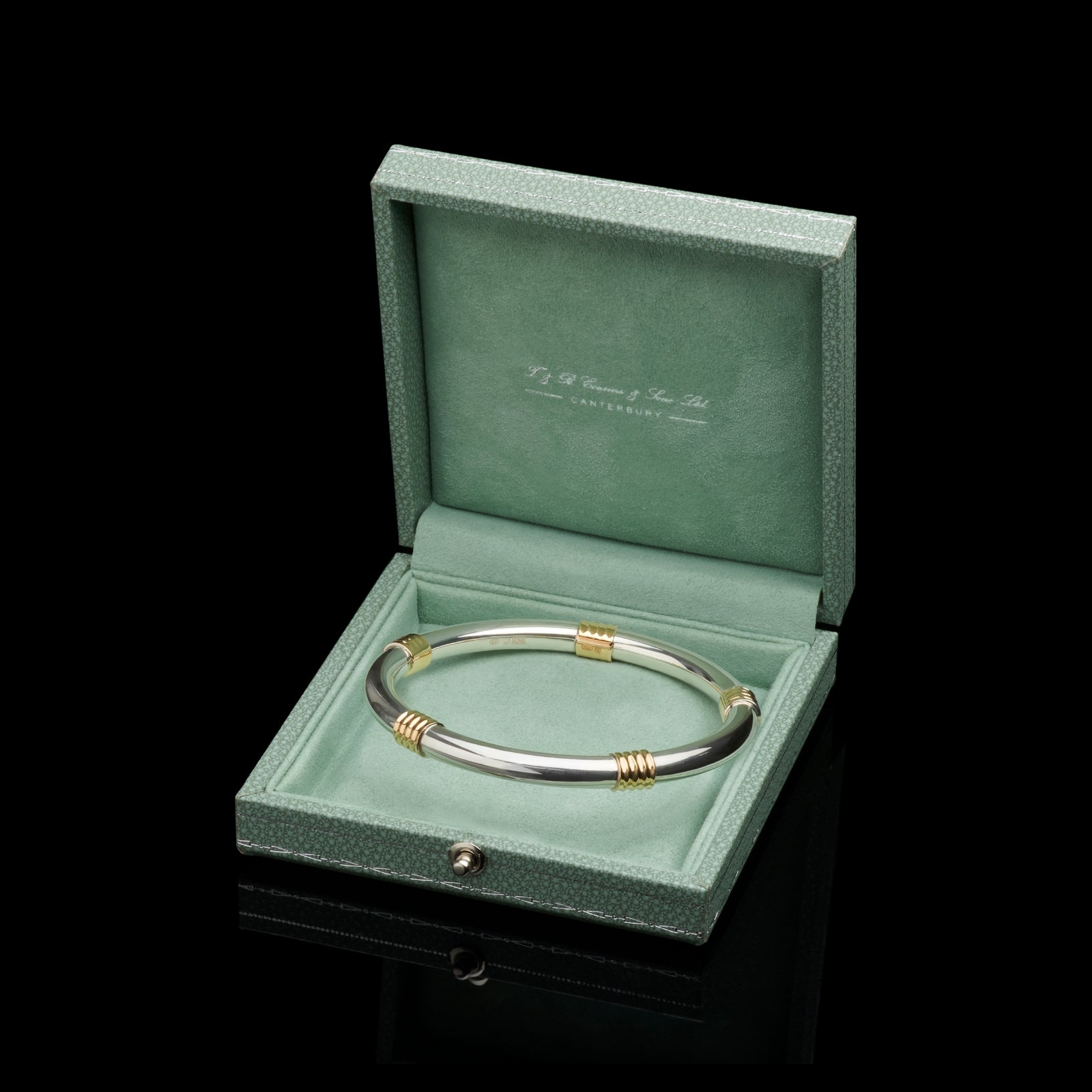 A Cousins ONE IN FIVE. A solid silver & 18 carat yellow gold bangle