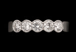 A Diamond Five Stone Half Hoop Half Eternity Ring with Scalloped Edge Settings