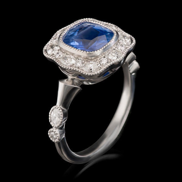 An undulating shaped sapphire & diamond cluster ring
