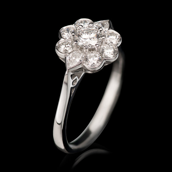 A classic diamond cluster ring with a subtle difference to make a distinctive surround