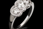 An all brilliant cut diamond triple cluster ring
