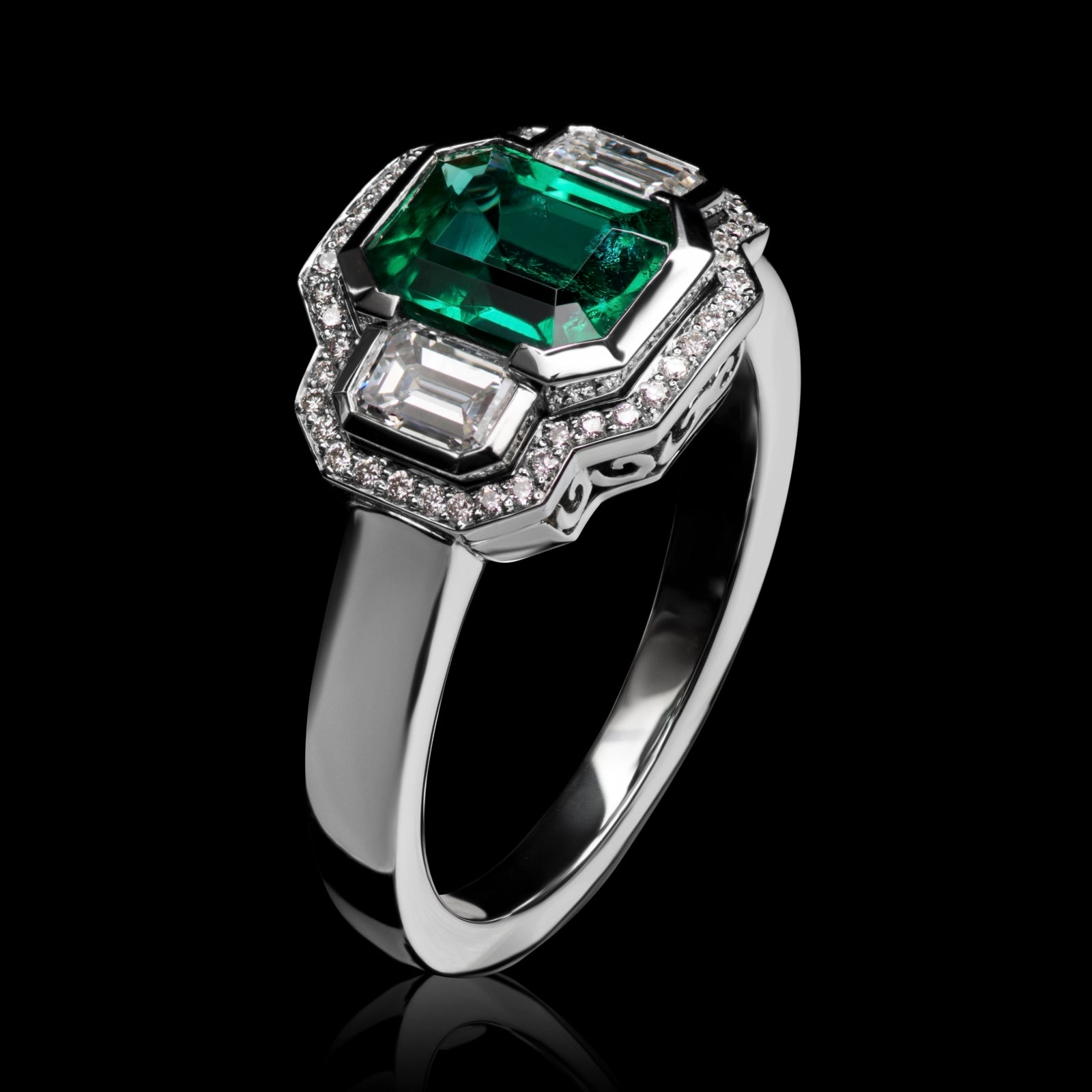 An Emerald & Diamond Three Stone Cluster Ring