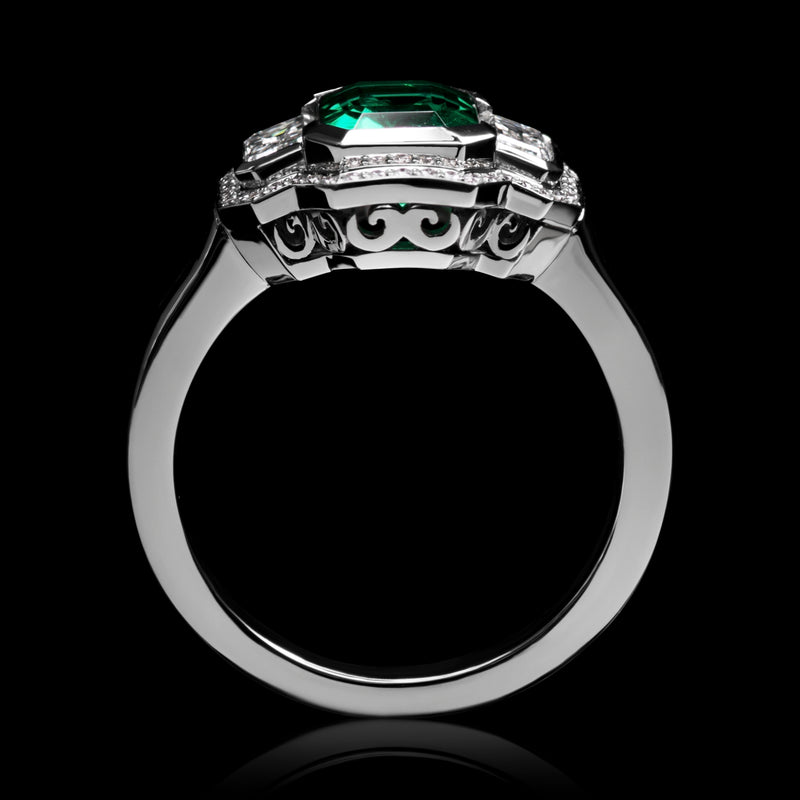 An Emerald & Diamond Three Stone Cluster Ring