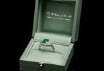 An Emerald & Diamond Three Stone Cluster Ring