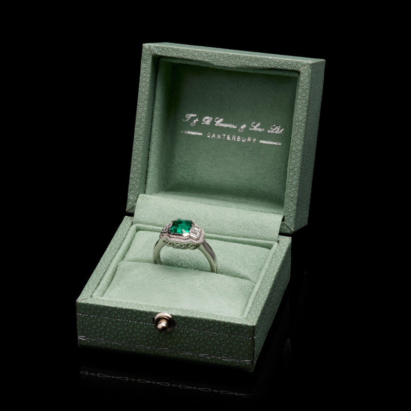 An Emerald & Diamond Three Stone Cluster Ring