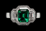 An Emerald & Diamond Three Stone Cluster Ring