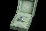 An Aquamarine single stone Ring with Diamond set shoulders.