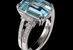 An Aquamarine single stone Ring with Diamond set shoulders.