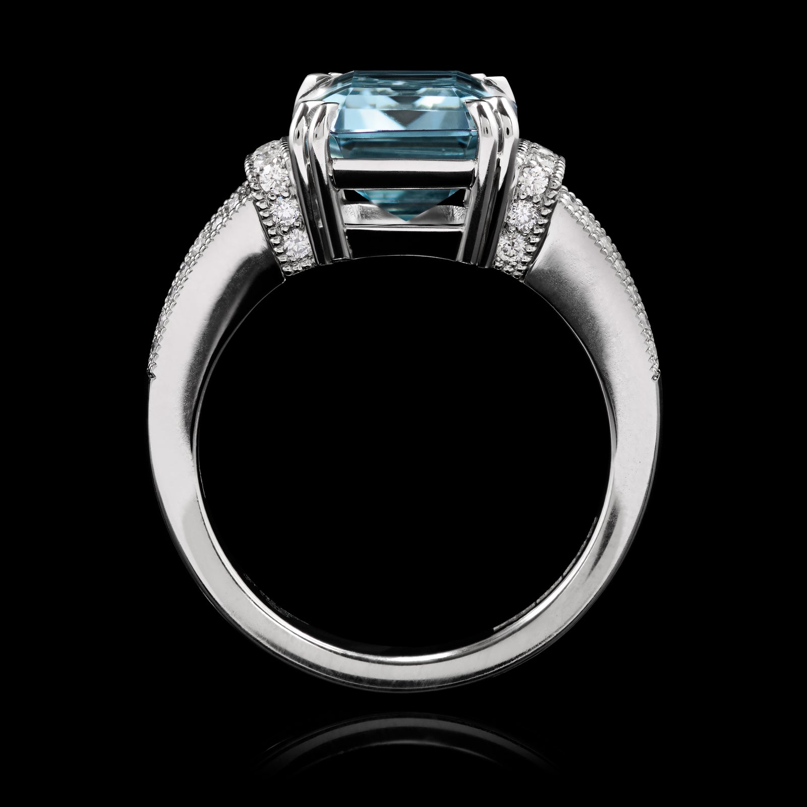 An Aquamarine single stone Ring with Diamond set shoulders.