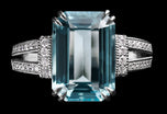 An Aquamarine single stone Ring with Diamond set shoulders.