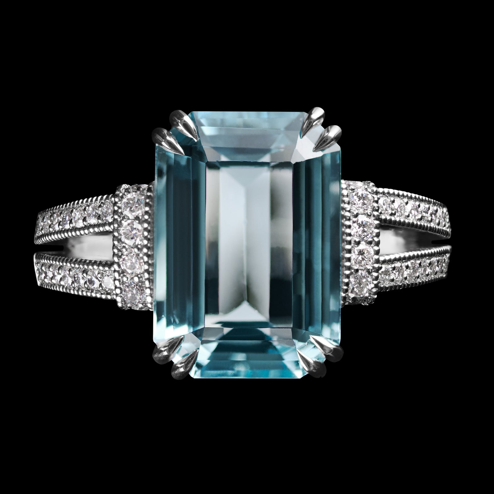 An Aquamarine single stone Ring with Diamond set shoulders.