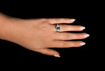 An Emerald & Diamond Three Stone Cluster Ring