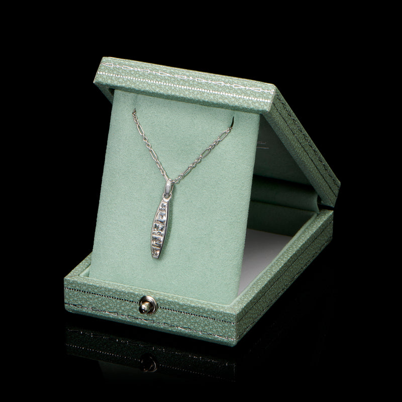 A diamond five stone tonneau baton pendant