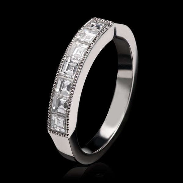 A Carree Cut Diamond Seven Stone Half Hoop Ring