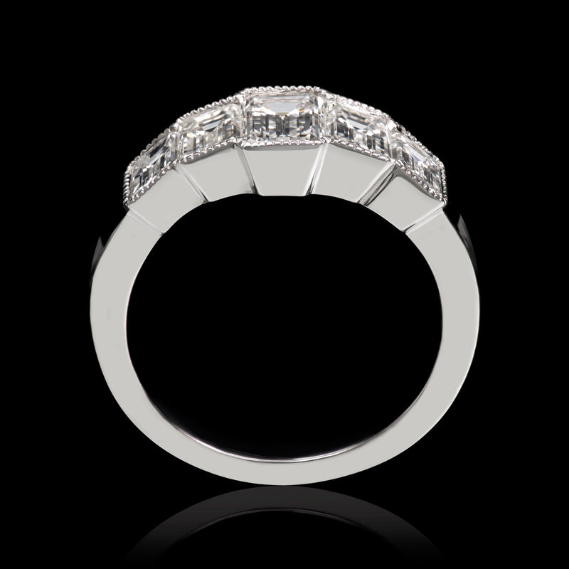 An Emerald Cut Diamond Five Stone Half Hoop Ring