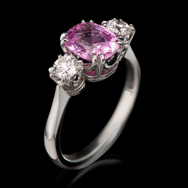 A glorious pink sapphire & diamond three stone ring