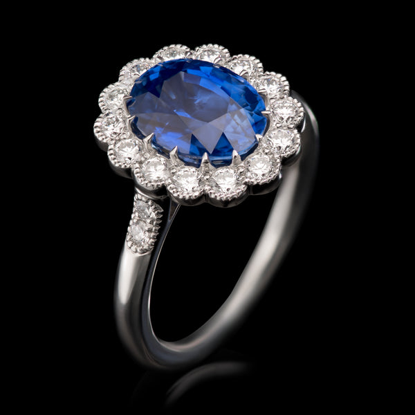 An exquisite oval sapphire & diamond cluster ring