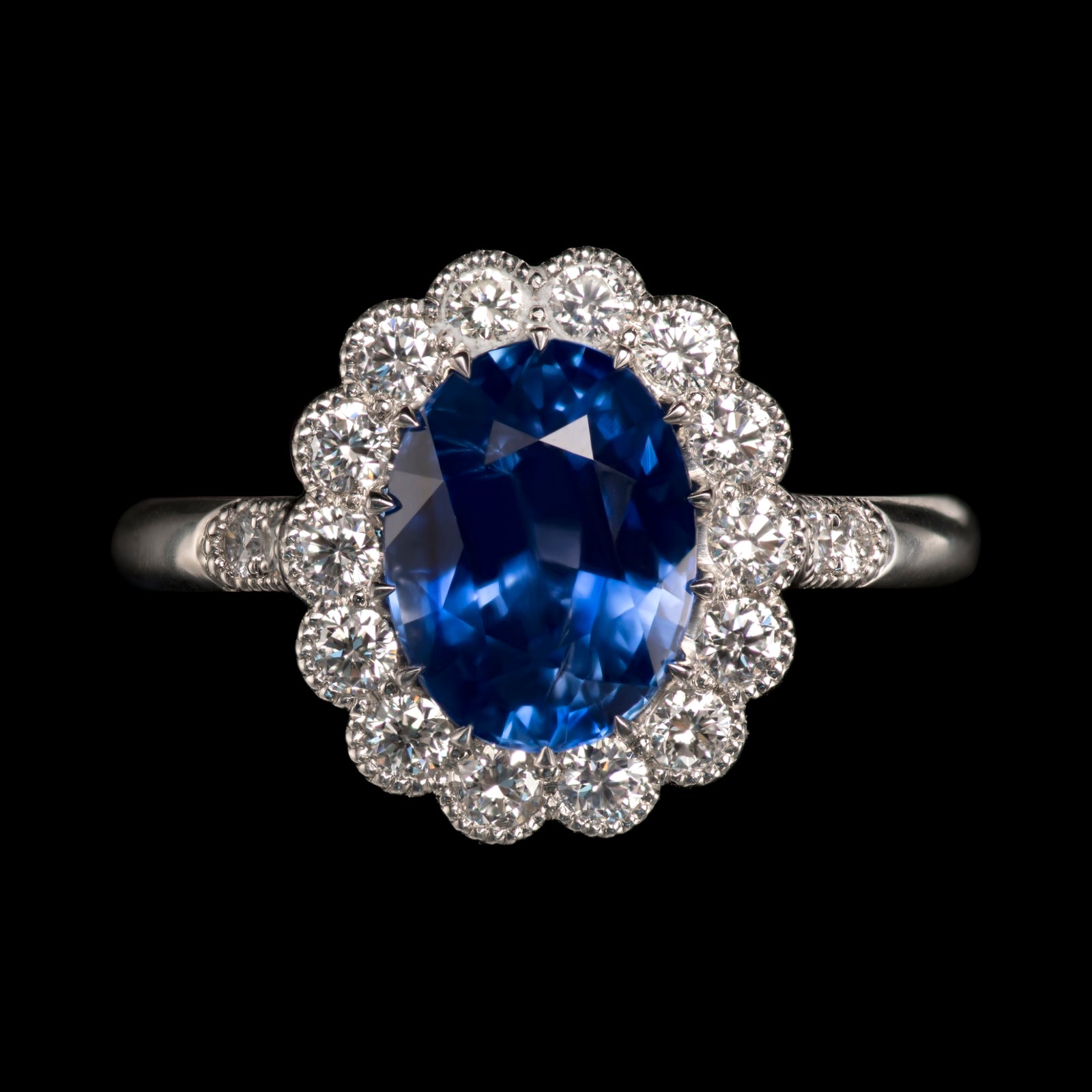 An exquisite oval sapphire & diamond cluster ring