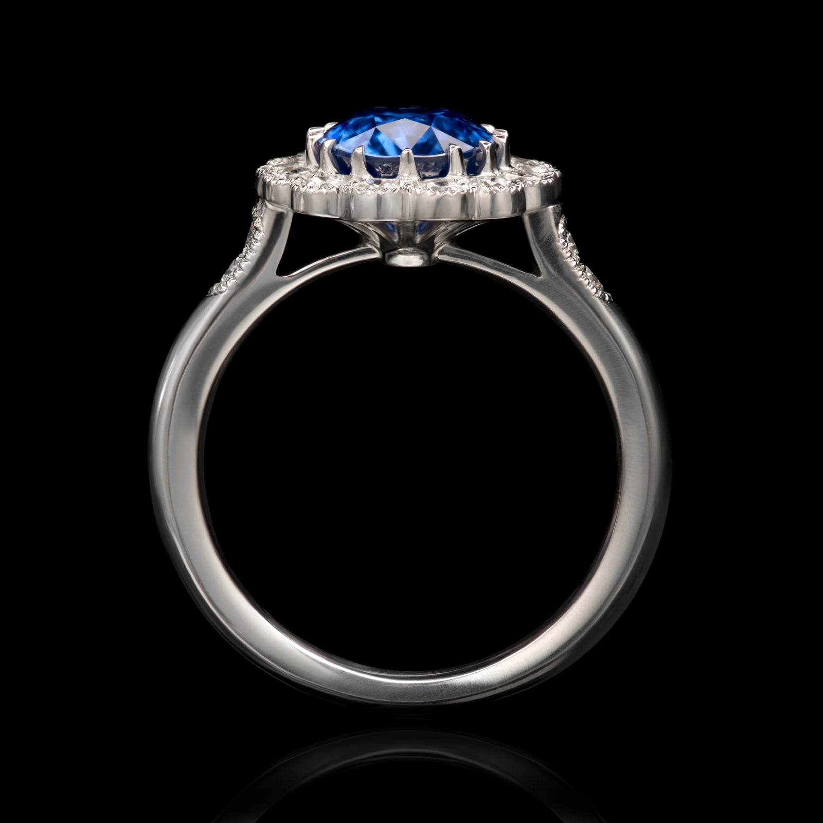 An exquisite oval sapphire & diamond cluster ring