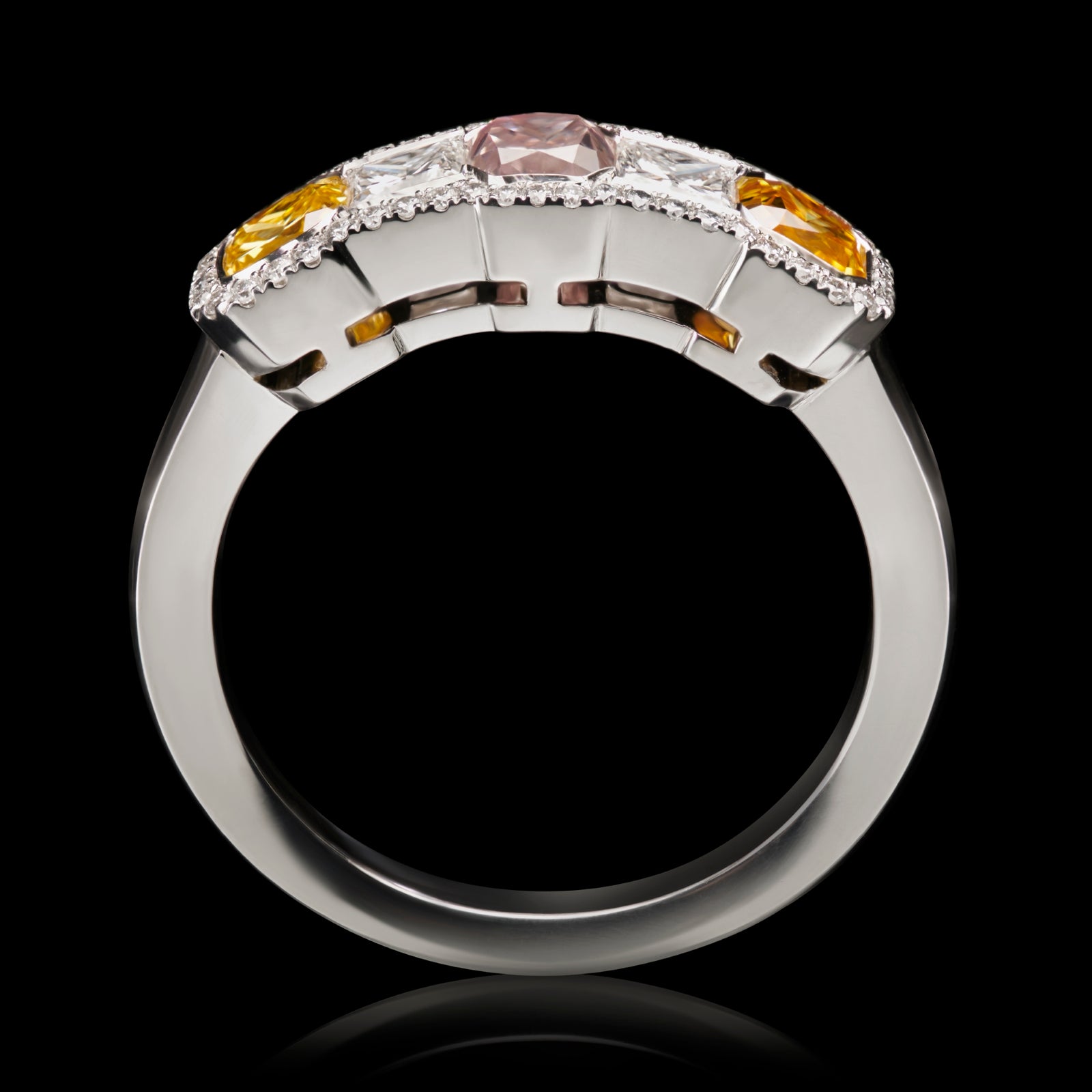 An all diamond half hoop ring with three fancy natural colour diamonds.