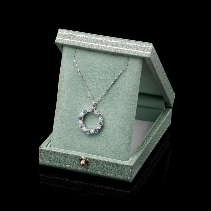 An Aquamarine & Diamond Circlet of Sixteen Pendant