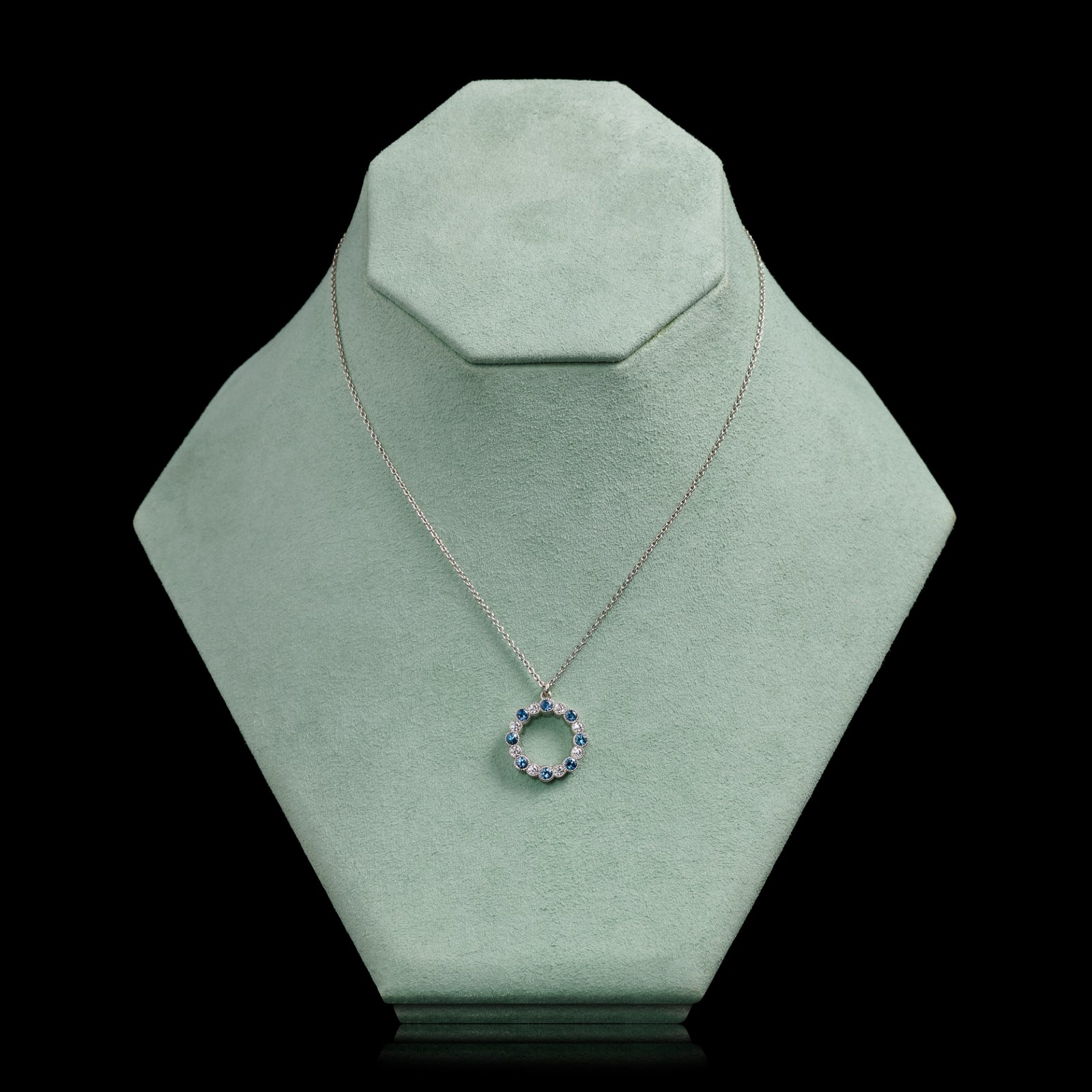 An Aquamarine & Diamond Circlet of Sixteen Pendant