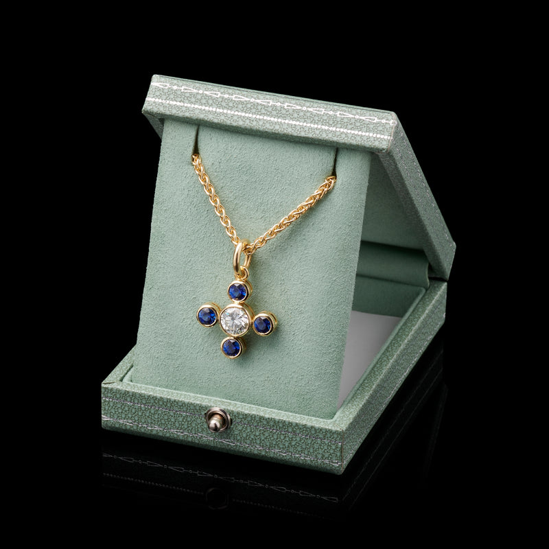 An amazing Sapphire Quatrefoil pendant with bold single stone Diamond centre